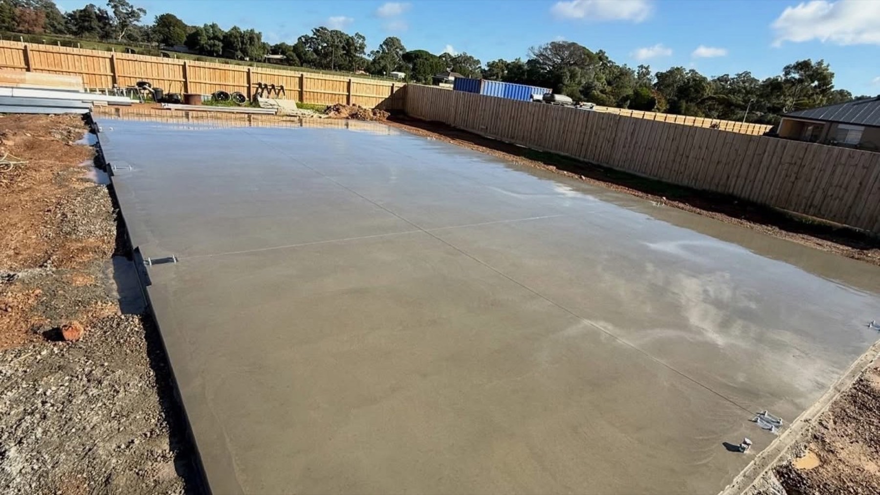 A broad concrete slab finished off across an open rural block