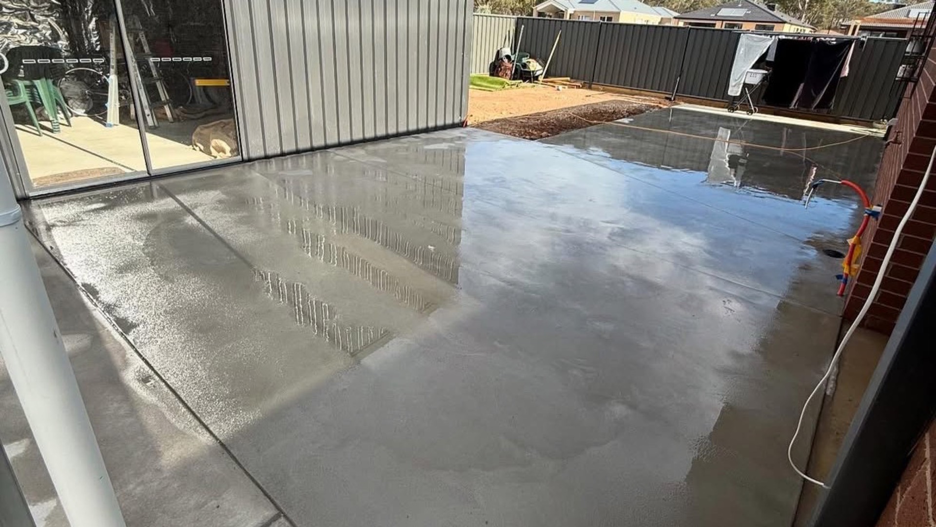 A concrete apron poured up to the roller doors of a shed