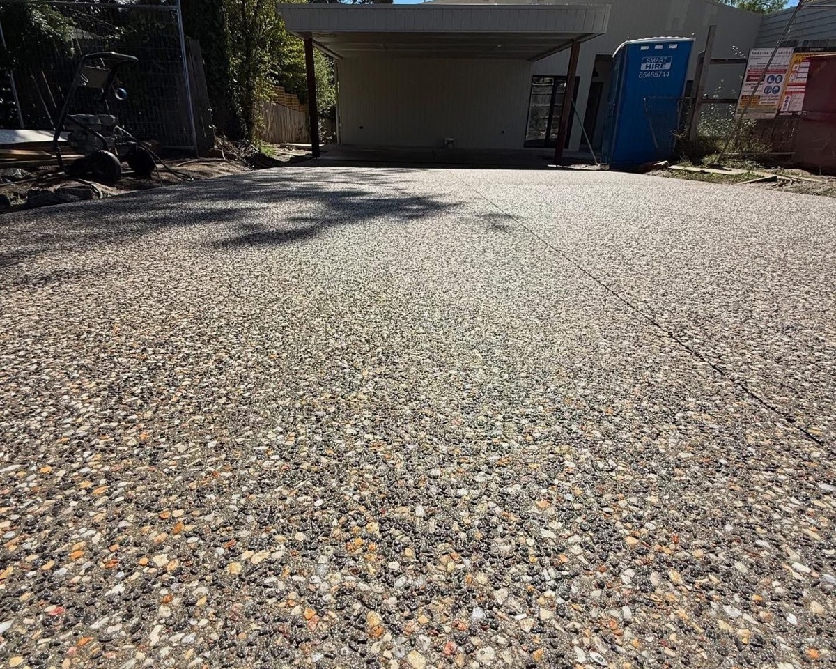 An exposed aggregate driveway with washed stone showing through the surface