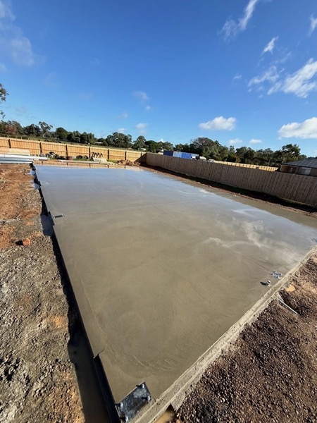 A large concrete slab finished off beside a bare rural block